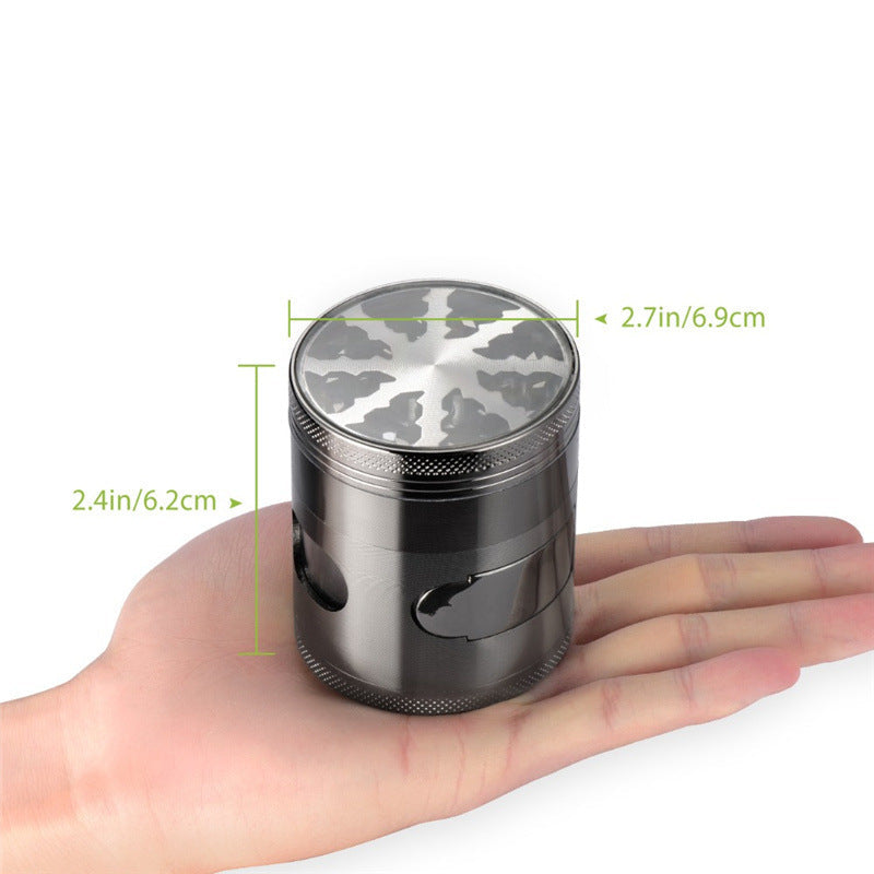 Hand holding a metallic grinder with dimensions indicated on a white background